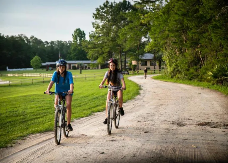 two girls riding bicycles - nature retreat in FL - Catholic Private School Retreats