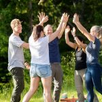 people hi fiving each other during a retreat - team building activities in florida concept