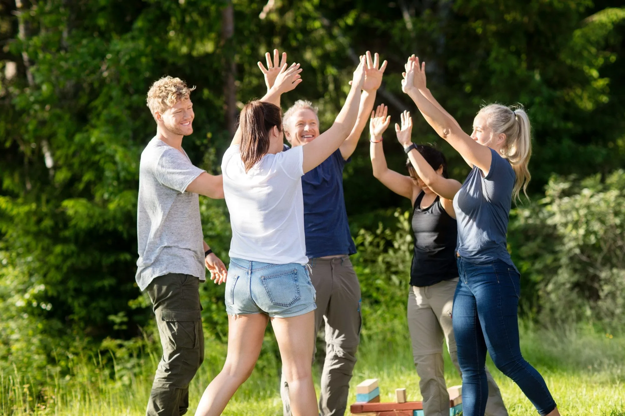 people hi fiving each other during a retreat - team building activities in florida concept