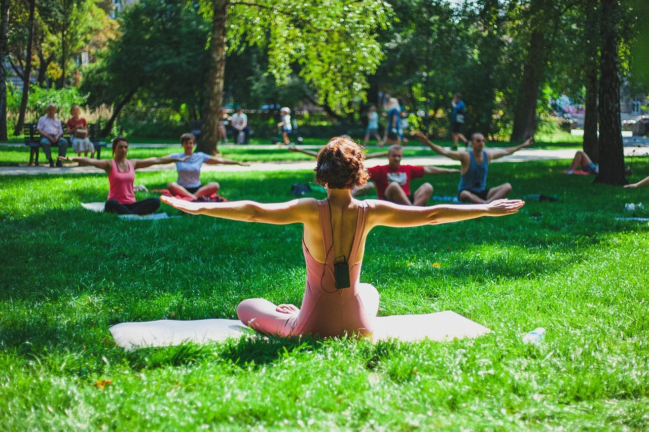 woman instructing yoga class outside in nature - connecting with nature