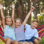 kids at nature camp enjoying outdoors in hammock