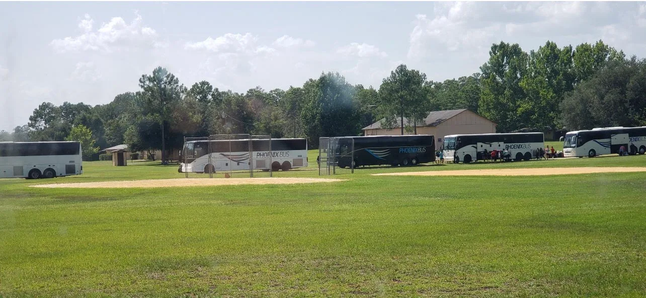 Buses lined up dropping off campers